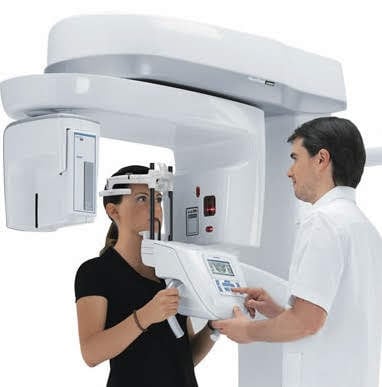 3D Imaging machine with patient and dental assistant 
