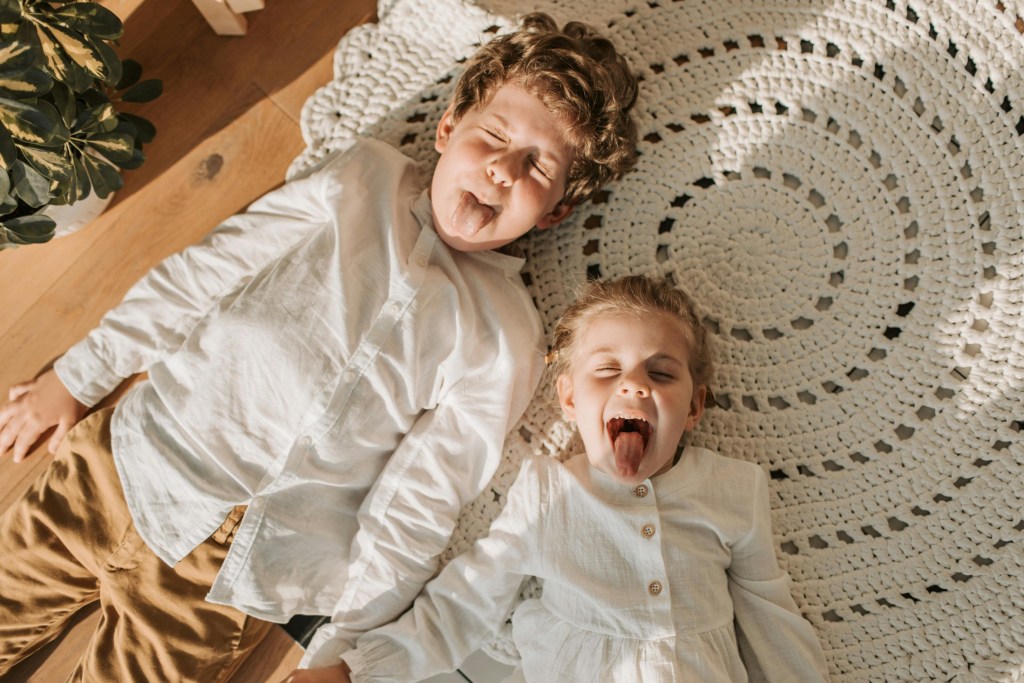 two children sticking tongues out